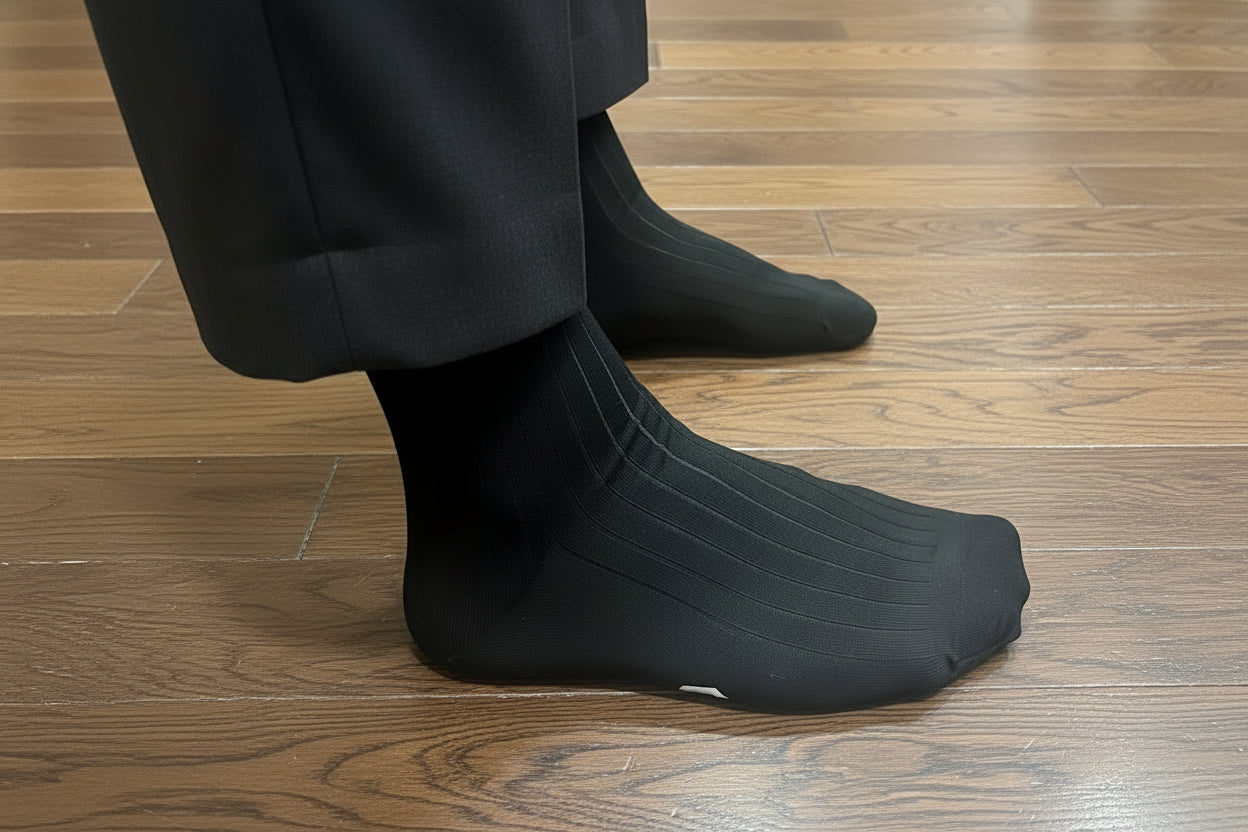 Black socks on a wooden floor